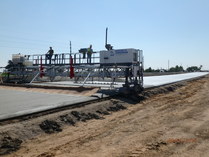 Burlap is dragged behind concrete truck to create texture on roadway surface