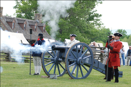 Photo of re-enactors firing a cannon