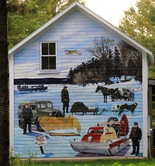 A painted mural on the side of a building depicting local Madeline Island culture - Beyer