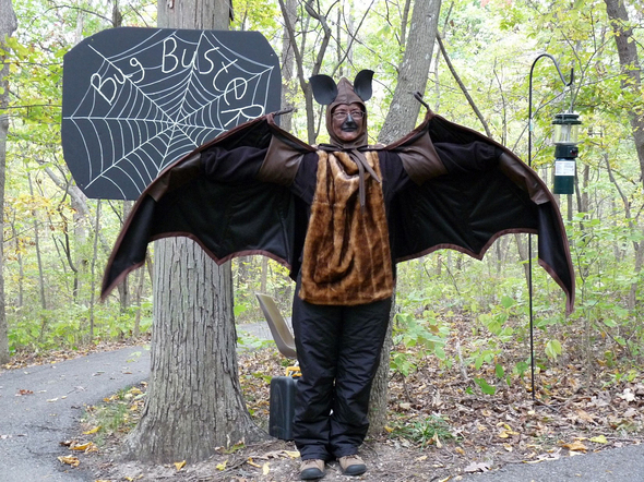 An MDC interpreter performs the part of a bat in costume and makeup on the Tanglevine Trail.