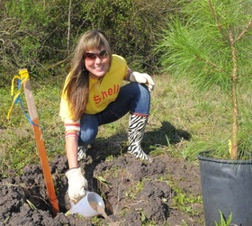volunteer woman planting a tree