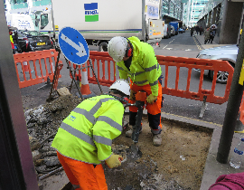 Trial hole being dug on Tottenham Court Road